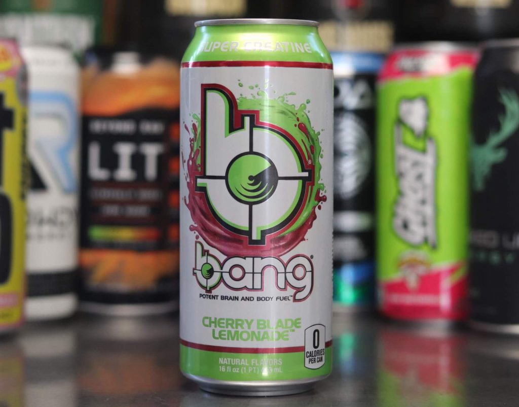 closeup of green and white can of bang energy cherry blade lemonade flavor with pink and green b logo with background of 6 other energy drink brands
