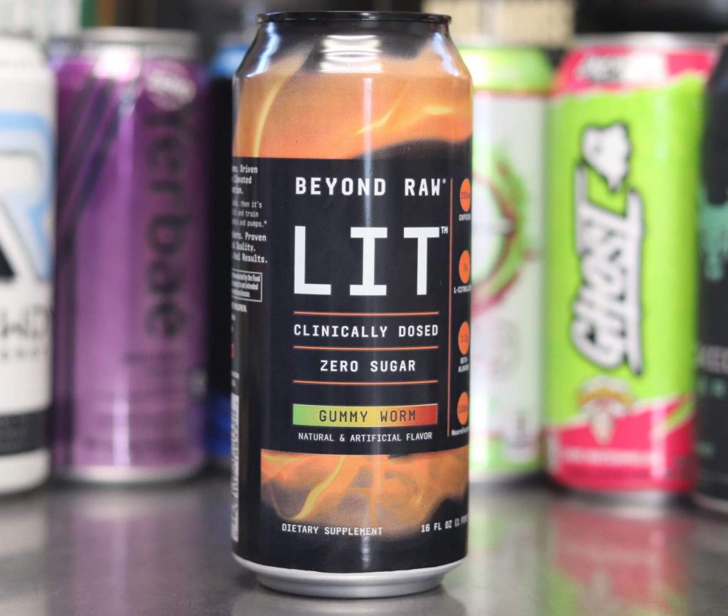 closeup of can of beyond raw lit clinically dosed gummy worm energy drink with orange and black with background of 6 other energy drink brands