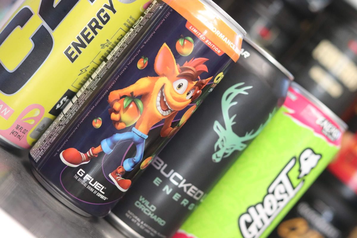 sideways image of four energy drink cans including c4 starburst, g fuel wumpa fruit, bucked up energy, and ghost energy