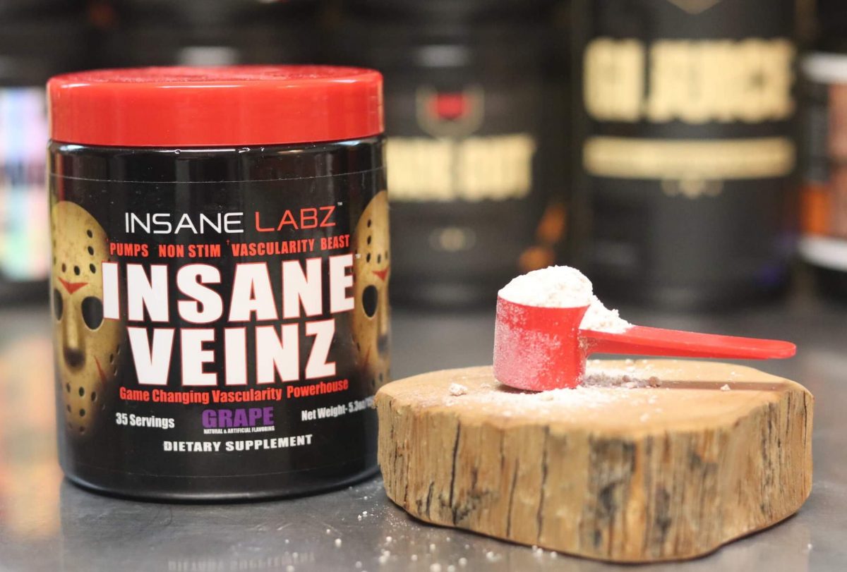 black tub of insane labz insane veinz pump formula with red lid and 2 jason horror masks on label next to wood block with red scoop heaped with white powder