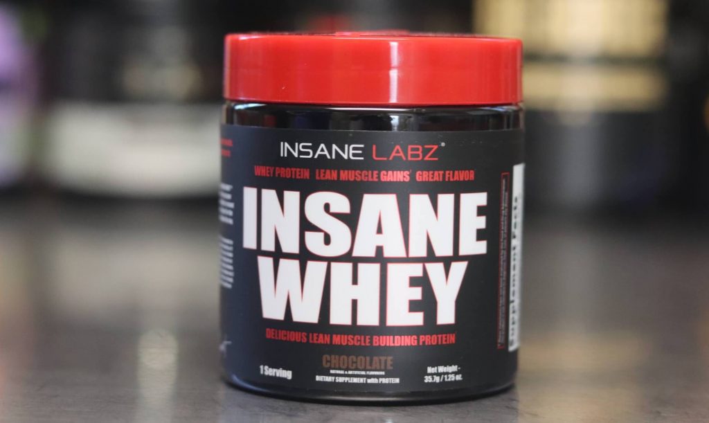 sample serving of Insane Labz Insane Whey lean muscle building protein chocolate flavor in black tub with red lid