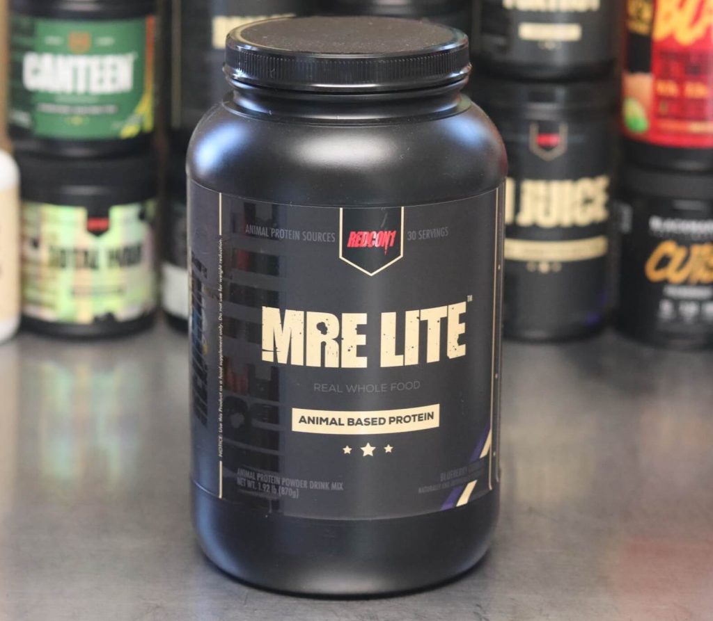 Large 1.92 pound 30-serving black tub of Redcon1 MRE Lite animal based protein powder with a black label reading blueberry cobbler