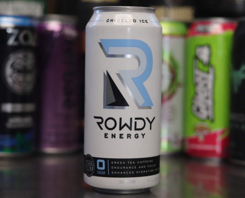 closeup of white can of rowdy energy blue, black and white R logo with background of 5 other energy drink brands